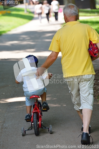 Image of happy grandfather and child in park