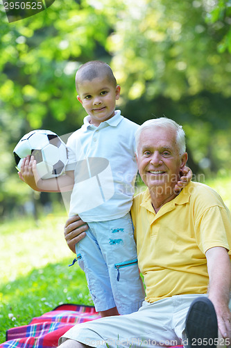 Image of happy grandfather and child in park