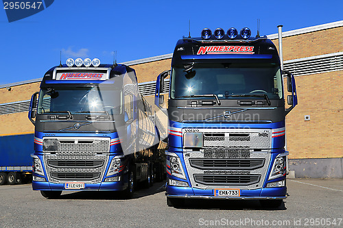 Image of Two New Volvo FH Tanker Trucks by a Warehouse