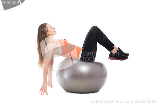 Image of Young blonde on grey fit ball