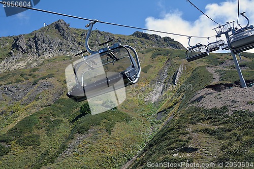 Image of Row of the empty ski lift chairs