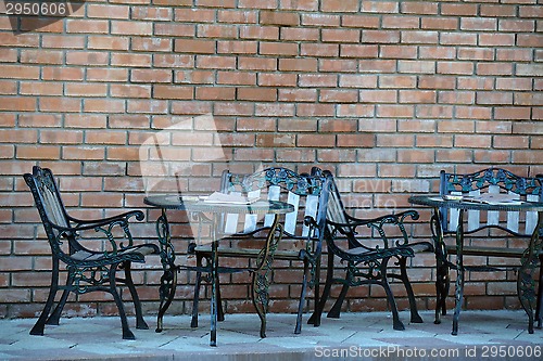 Image of Beaten metal cafe tables and chairs