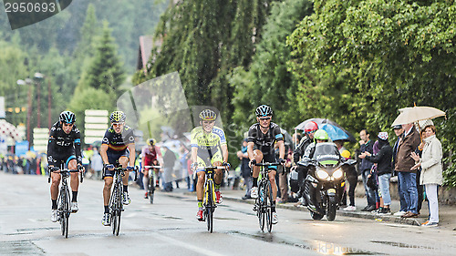 Image of Four Cyclists Riding in the Rain