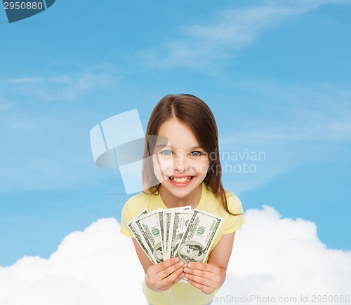 Image of smiling little girl with dollar cash money
