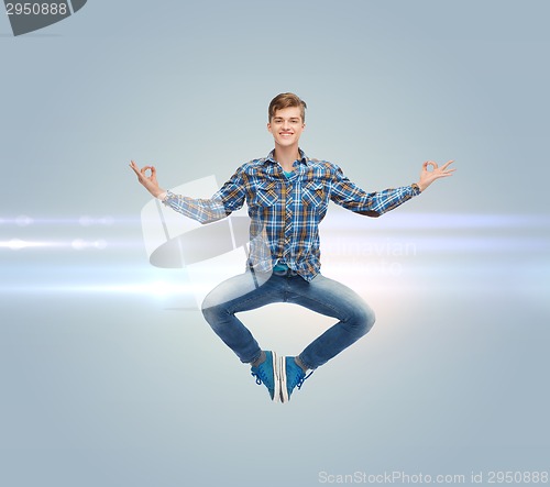 Image of smiling young man jumping in air