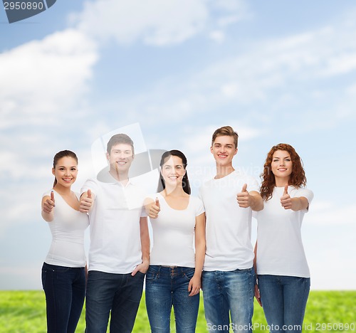 Image of smiling teenagers in t-shirts showing thumbs up