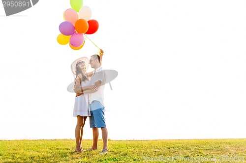 Image of smiling couple with air balloons outdoors