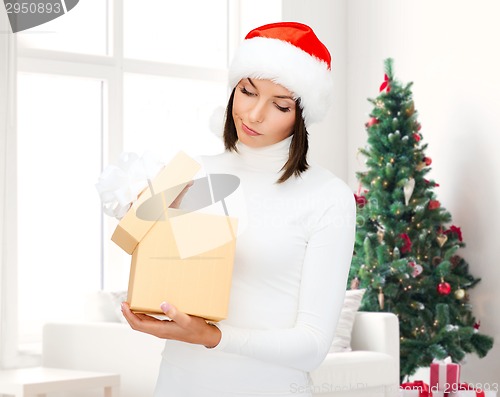 Image of woman in santa helper hat with gift box