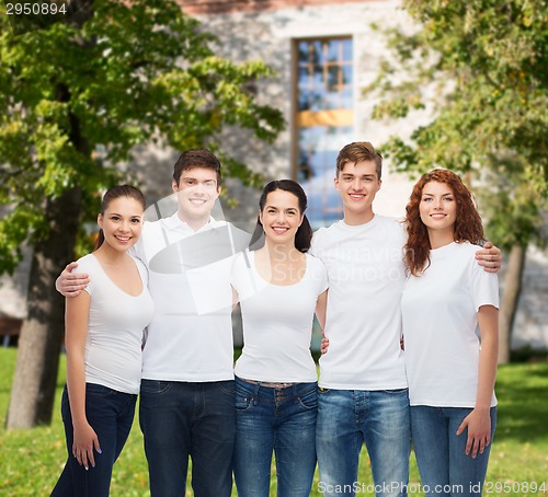 Image of group of smiling teenagers in white blank t-shirts