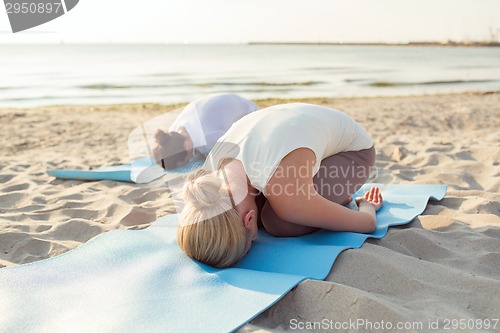 Image of close up of couple making yoga exercises outdoors