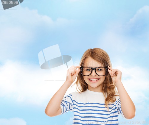 Image of smiling cute little girl with black eyeglasses