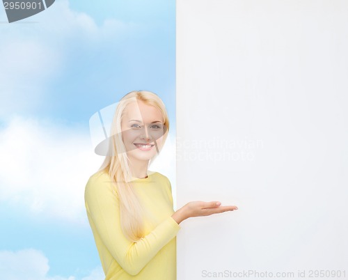 Image of smiling woman in sweater with blank white board