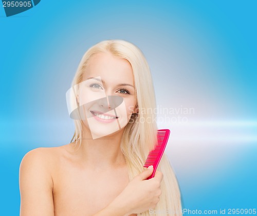 Image of smiling woman with hair brush