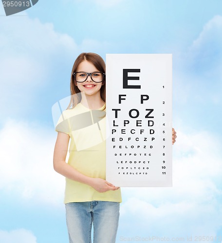 Image of little girl in eyeglasses with eye checking chart