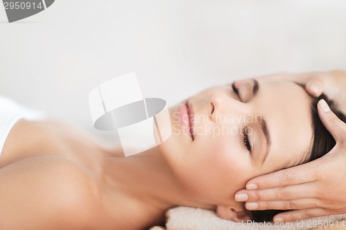 Image of beautiful woman in spa salon having facial