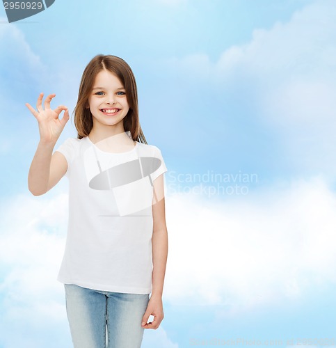 Image of smiling little girl in white blank t-shirt