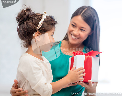 Image of happy mother and child girl with gift box