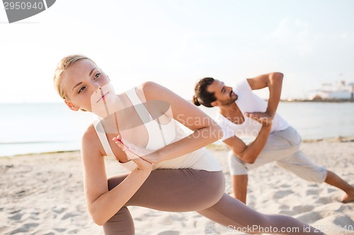 Image of close up of couple making yoga exercises outdoors