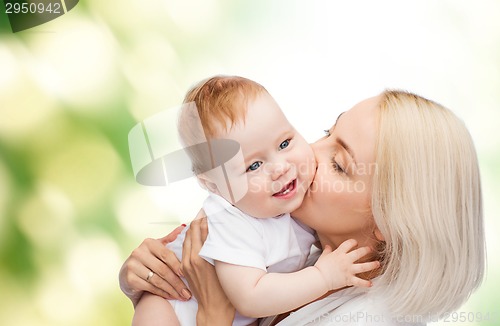 Image of happy mother kissing smiling baby