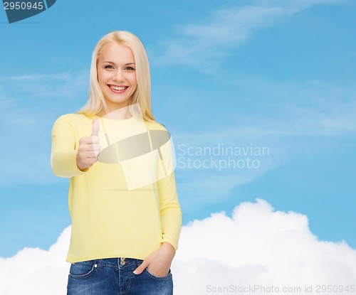 Image of smiling girl in casual clothes showing thumbs up