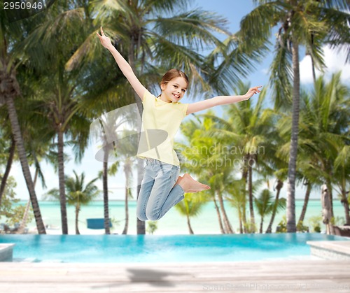 Image of smiling little girl jumping