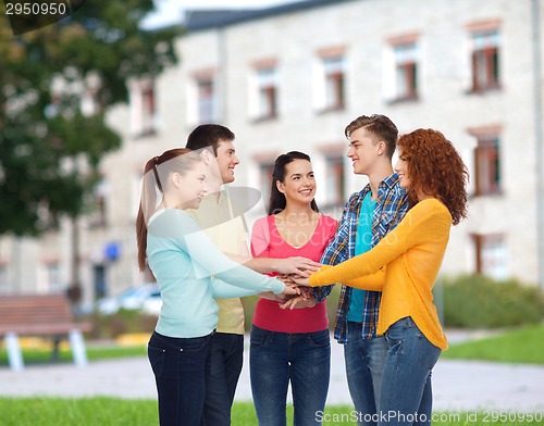 Image of group of smiling teenagers over campus background