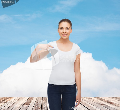 Image of smiling young woman in blank white t-shirt