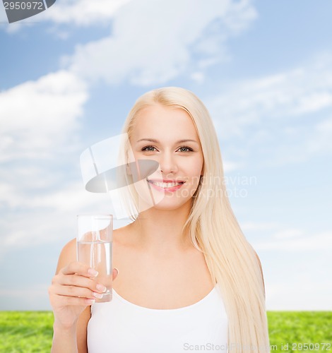 Image of young smiling woman with glass of water