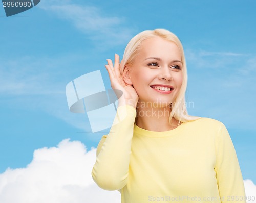 Image of smiling young woman listening to gossip