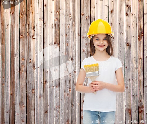 Image of smiling little girl in helmet with paint brush