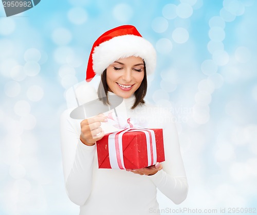 Image of smiling woman in santa helper hat with gift box