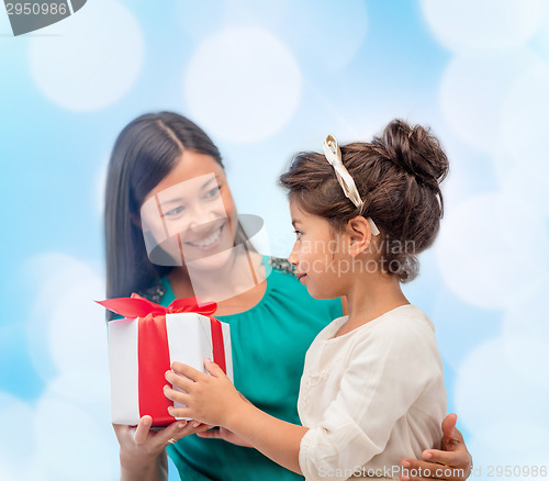 Image of happy mother and child girl with gift box