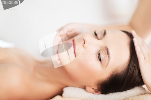 Image of beautiful woman in spa salon having facial