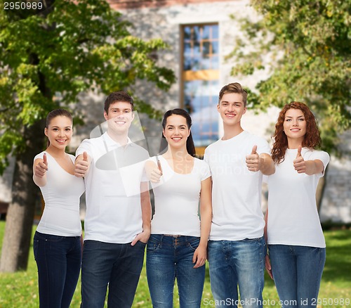 Image of smiling teenagers in t-shirts showing thumbs up