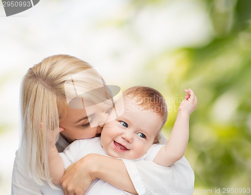 Image of happy mother kissing smiling baby