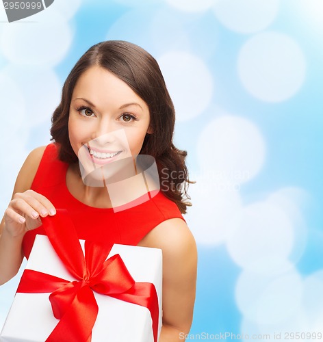 Image of smiling woman in red dress with gift box