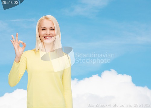 Image of young businesswoman showing ok sign