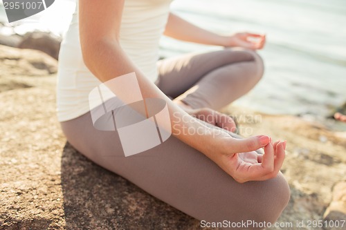 Image of close up of woman making yoga exercises outdoors