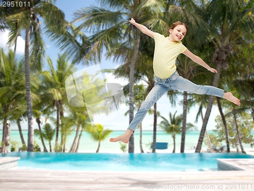 Image of smiling little girl jumping