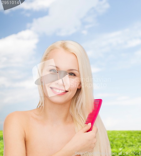 Image of smiling woman with hair brush