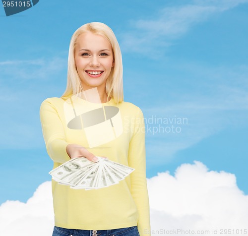 Image of smiling girl with dollar cash money