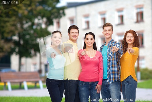 Image of group of smiling teenagers over campus background