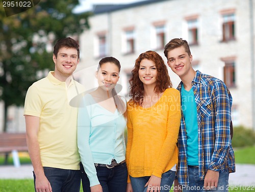 Image of group of smiling teenagers over campus background