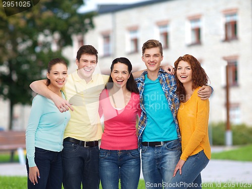 Image of group of smiling teenagers over campus background