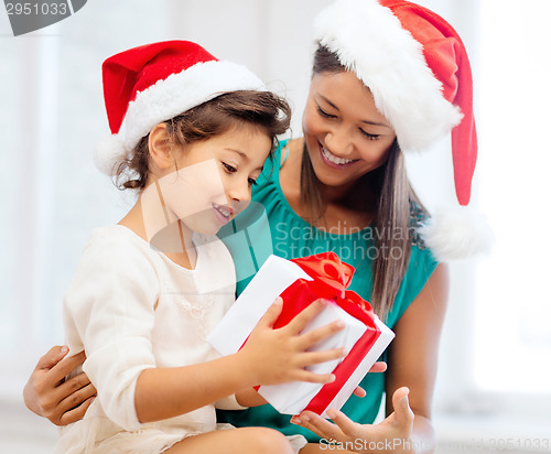 Image of happy mother and child girl with gift box