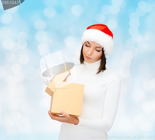 Image of woman in santa helper hat with gift box