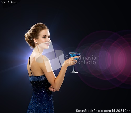 Image of smiling woman holding cocktail