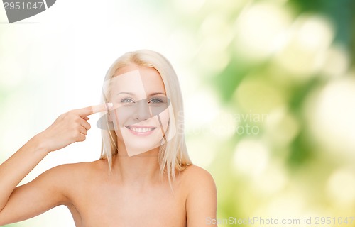 Image of beautiful woman touching her eye area