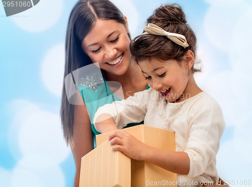 Image of happy mother and child girl with gift box