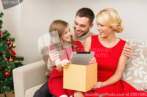 Image of smiling family with tablet pc